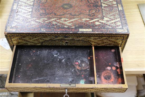 A Chinese export lacquer artists box, containing ceramic dishes